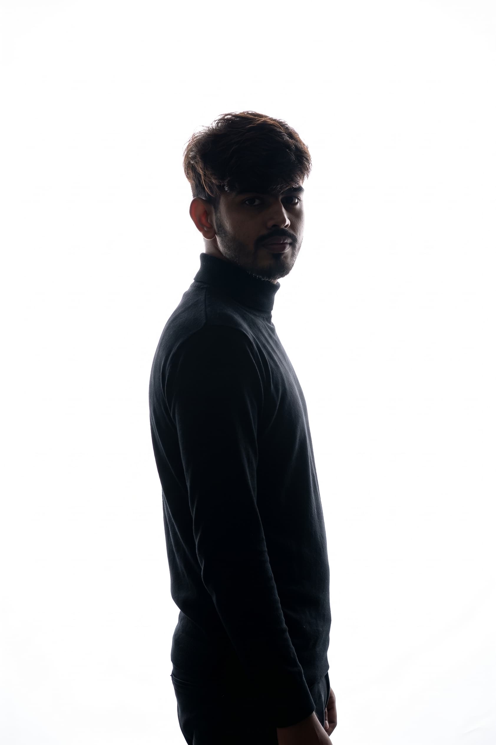 Danish Ahmad in profile, almost a silhouette — the work that doesn't photograph.