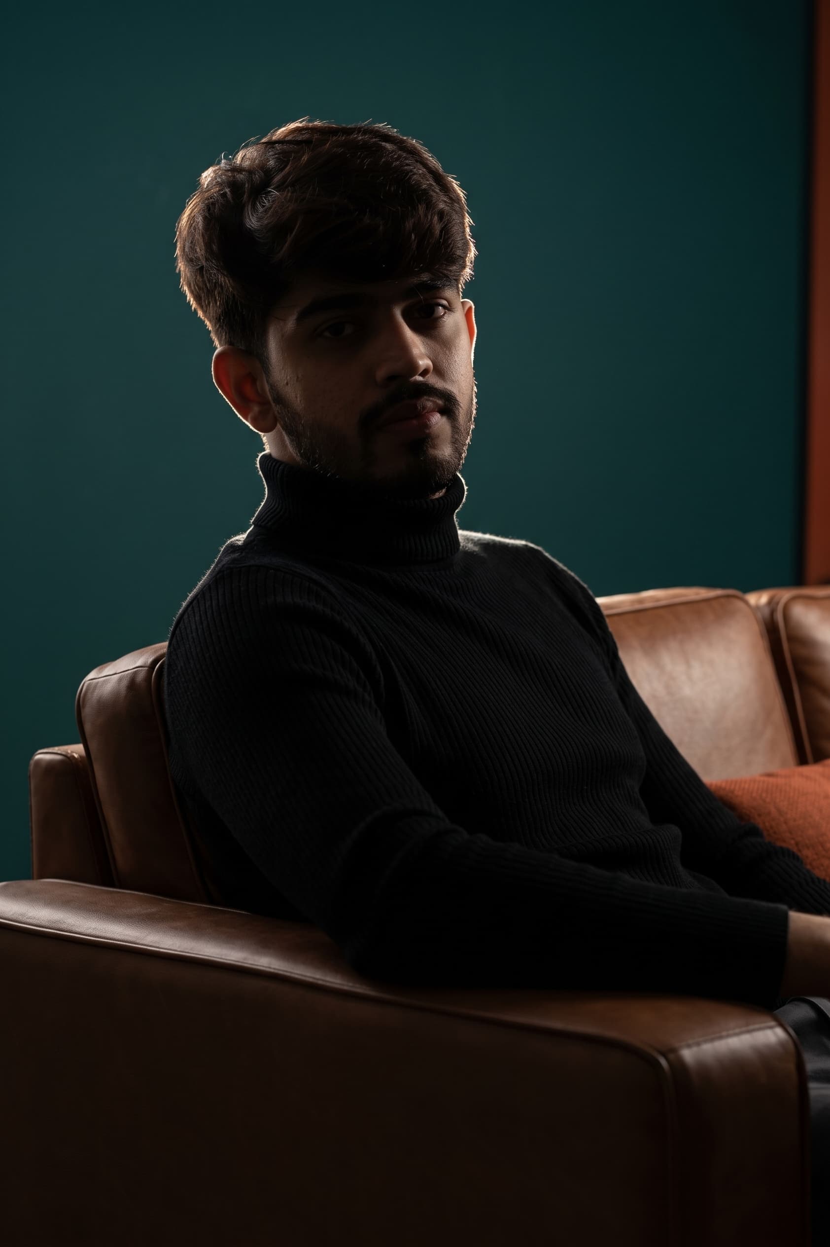 Danish Ahmad, seated, looking at the camera.